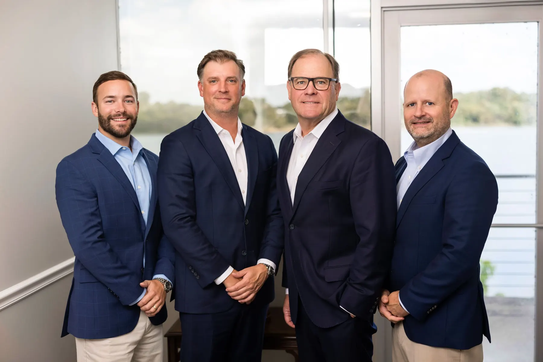 TMB advisors Zack Sokora, Ben Bailey, Scott Tabor and William McMillan in their Little Rock office overlooking the Arkansas River