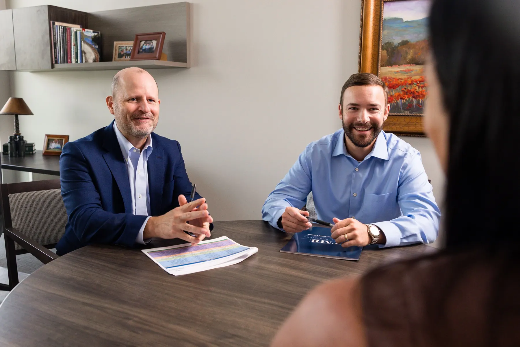 Ben Bailey and Zack Sokora reviewing a plan with clients