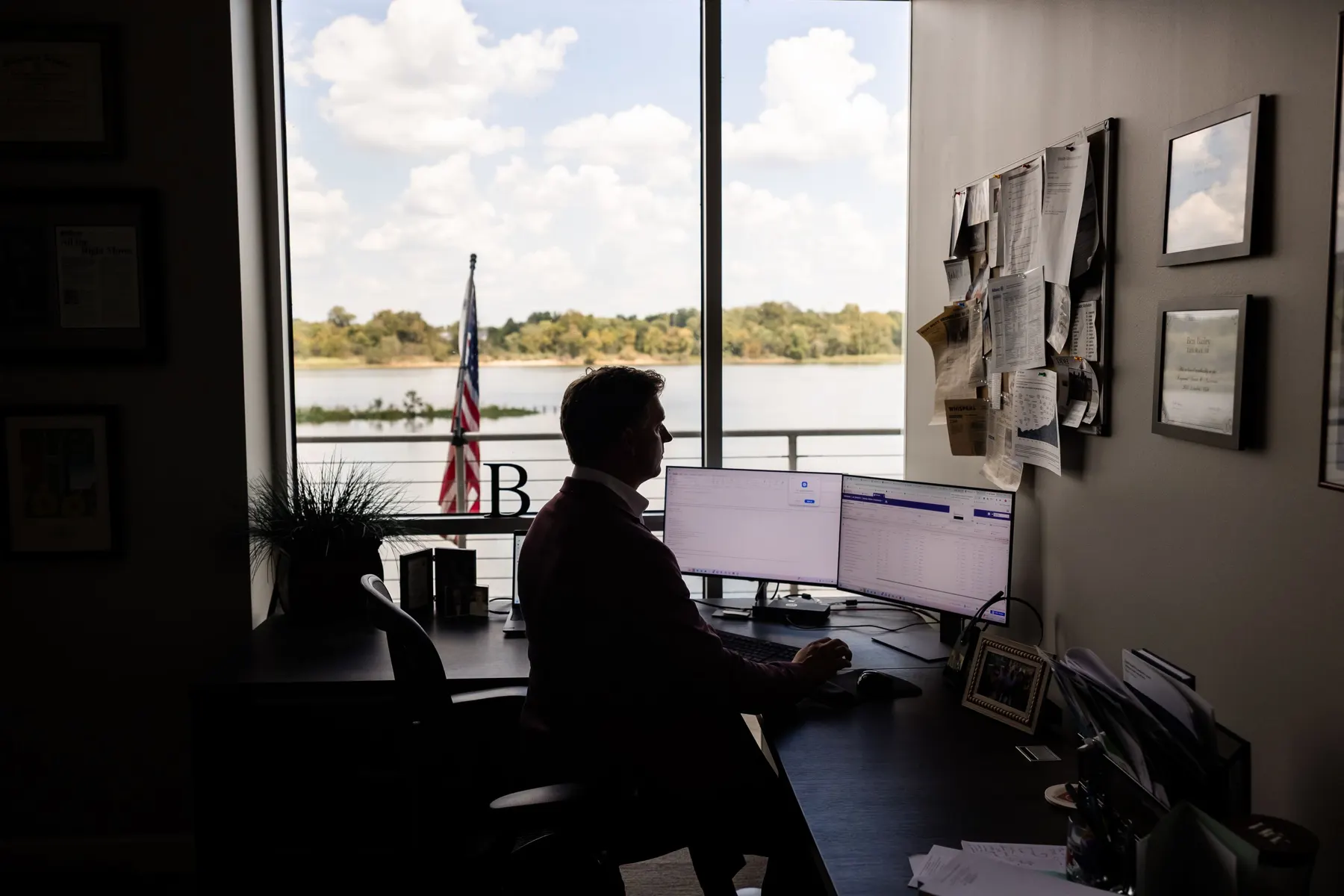 An advisor's desk with a view of the Arkansas River from TMB's Cottondale Lane office